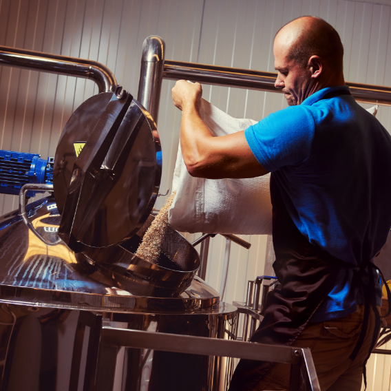 Man pouring grains into bin